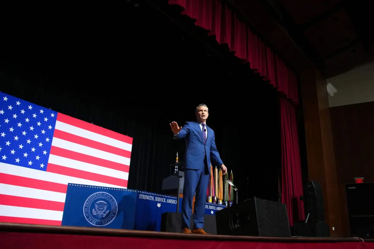 Atravessando o palco em frente a uma bandeira americana gigante semelhante ao seu lenço de bolso, Hegseth atacou as "regras de combate estúpidas" no campo de batalha e as "tropas gordas" em casa