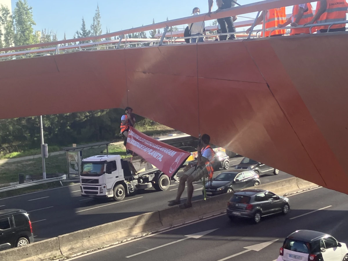 Ativistas climáticos pendurados numa ponte pedonal depois de bloquearem segunda circular