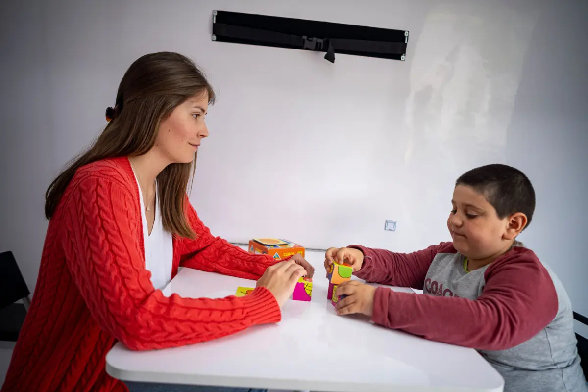 Gabriel, com sete anos, faz terapia na unidade móvel que vai à escola de Valença