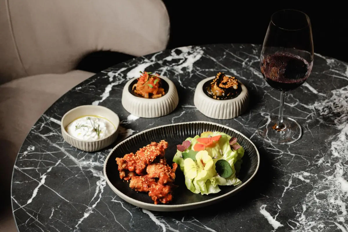 Frango frito com molho coreano, kimchi, sunomono e tzatziki.