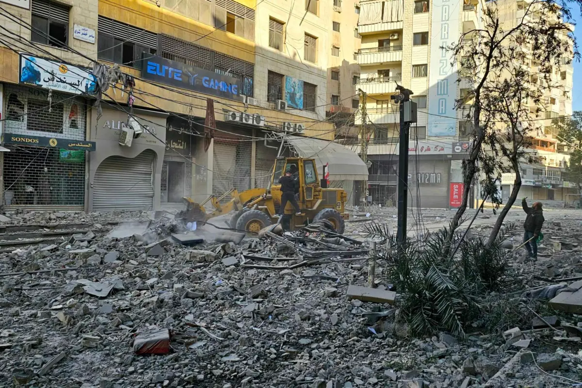 Workers use a bulldozer to clear debris from a street at the site of overnight Israeli airstrikes in the southern suburbs of Beirut on March 6, 2026. Heavy attacks were reported in Tehran on March 6 after Israel said it was hitting "regime infrastructure" in a "new phase" of the war it launched with the United States against Iran. As the conflict entered its seventh day, its regional repercussions continued -- with Qatar saying it intercepted a drone targeting a US base, and Lebanon reporting the death toll from Israeli strikes had risen to 123. (Photo by AFP)