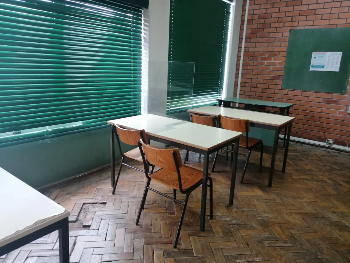 Uma sala de aulas com piso esburacado