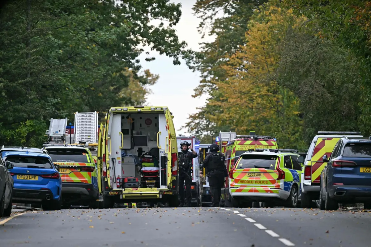 Armed Police officers stand by emergency vehicles outside Heaton Park Hebrew Congregation synagogue in Crumpsall, north Manchester, on October 2, 2025, following an attack at the synagogue. Two people were killed and three wounded in a car ramming and stabbing incident outside a synagogue in Manchester, northwest England, on Thursday, police said. "A man believed to be the offender was shot by GMP (Greater Manchester Police) Firearms Officers and is also believed to be deceased," the force said on X, adding his death could not yet be confirmed due to "suspicious items on his person". (Photo by Oli SCARFF / AFP)