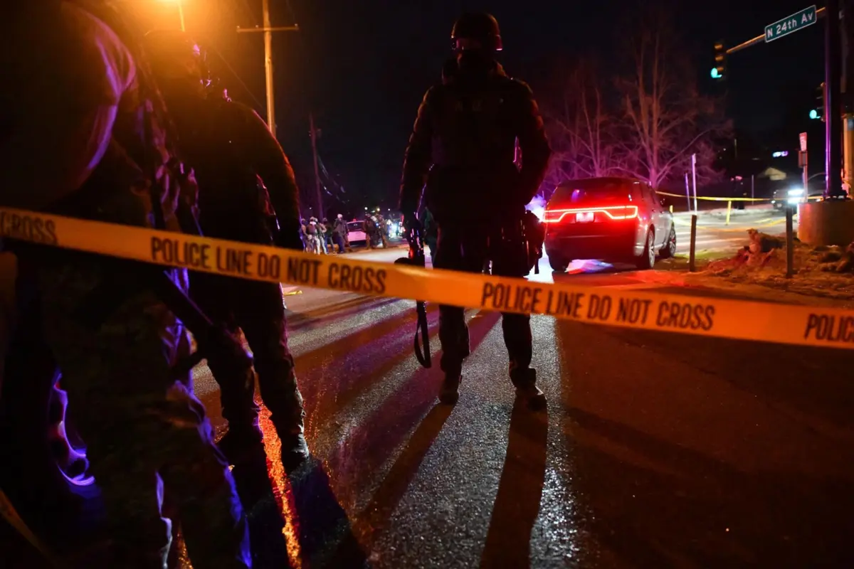 Federal law enforcement agents and police officers in riot gear stand behind a police tape as protests broke out following the shooting of a Venezuelan man by a Immigration and Customs Enforcement (ICE) agent in Minneapolis, Minnesota, on January 14, 2026. A federal immigration agent shot a man January 14 in Minneapolis, city officials said, urging the public to "remain calm" a week after agents shot and killed an American woman in the same city.
Minneapolis Police Chief Brian O'Hara said the shooting resulted from a struggle in front of a residence between a man and an Immigration and Customs Enforcement (ICE) agent on the north side of the city. (Photo by Octavio JONES / AFP)