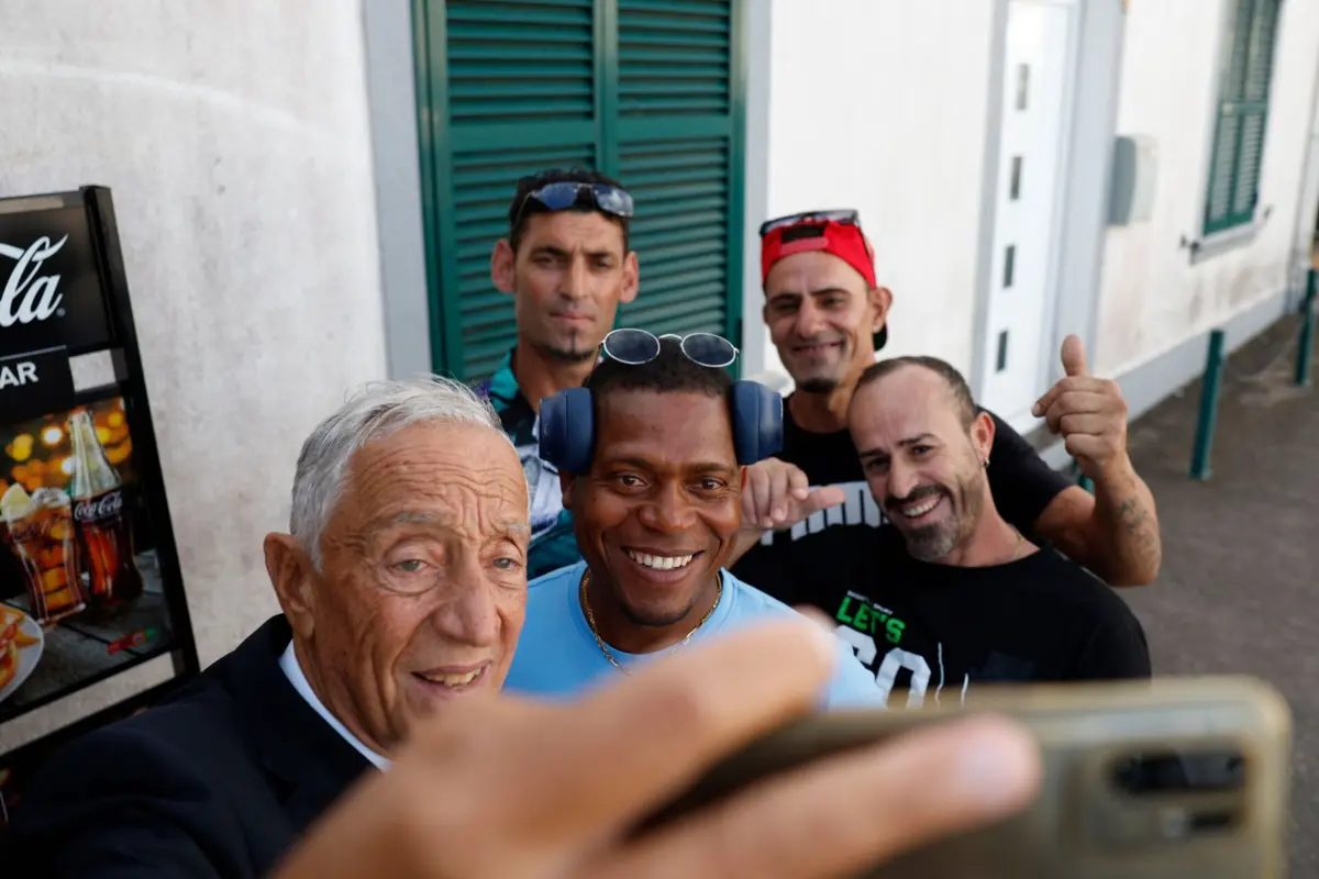 Marcelo tira fotografia com pessoas à porta de um café na ilha de Santa Maria, nos Açores