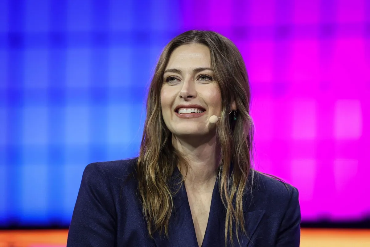 Russian tennis player Maria Sharapova arrives on stage at the Web Summit at Parque das Nacoes in Lisbon, on November 10, 2025. The Web summit, the annual gathering of the digital economy and new technologies, will take place from November 10 to 14. (Photo by PATRICIA DE MELO MOREIRA / AFP)