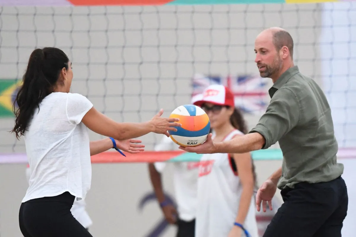 Britain's Prince William, Prince of Wales, plays volleyball at a meeting with first responder lifeguards at Copacabana Beach in Rio de Janeiro, Brazil on November 3, 2025. Prince William visits Brazil to host the Earthshot Prize awards and will later attend the UN COP30 climate summit on behalf of King Charles. (Photo by Daniel RAMALHO / AFP)