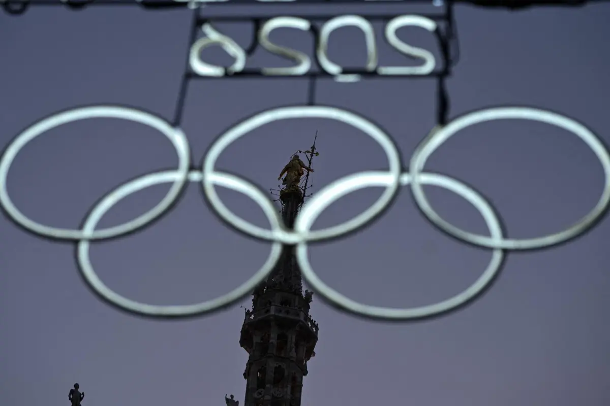 Olympic rings illuminations are pictured in Piazza Duomo ahead of the Milano Cortina 2026 Olympic Games, in Milan on January 26, 2026. (Photo by Piero CRUCIATTI / AFP)