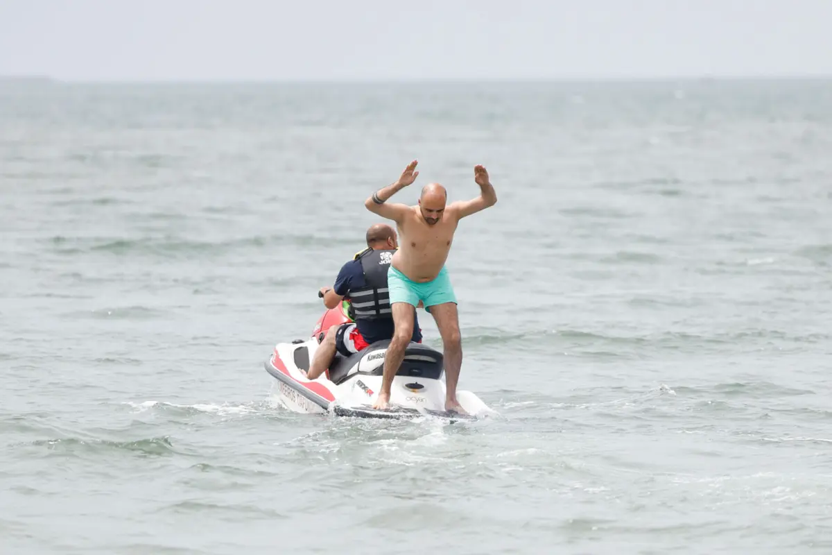 Sem t-shirt, descalço e com calções de banho verdes, Fidalgo Marques entra para a mota de água e passados uns minutos mergulha